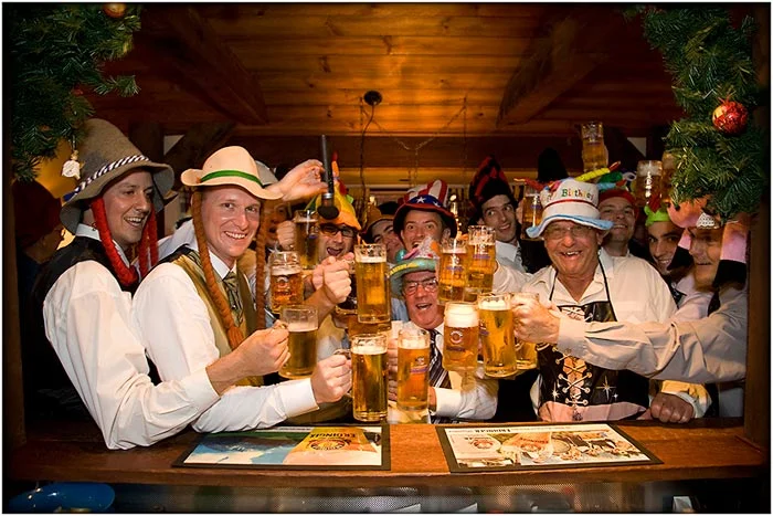 A group of people enjoying a beer at a bar during sunshine coast day trips.