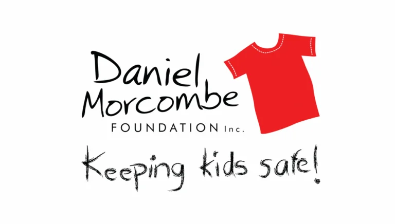 The image shows the logo of the Daniel Morcombe Foundation Inc., featuring text in a hand-drawn style. There is a red T-shirt illustration to the right of the text. Below it, the slogan "Keeping kids safe!" is written in a similar hand-drawn style.